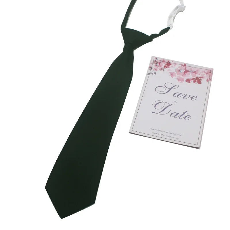 A black necktie with a butterfly ribbon and a save the date card.