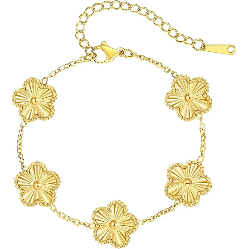 A gold plated stainless steel double-sided petal bracelet with a chain and floral charms.