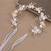 Elegant floral wreath headband featuring white and pink flowers and pearl accents