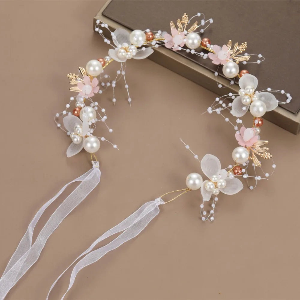 Elegant floral wreath headband featuring white and pink flowers and pearl accents
