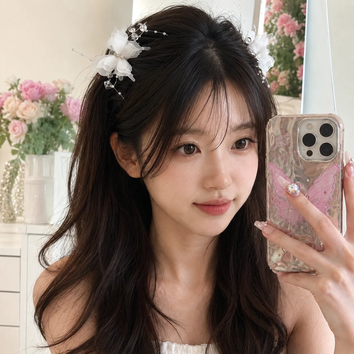 A woman with long dark hair wearing a pearl rhinestone butterfly hair claw clip.