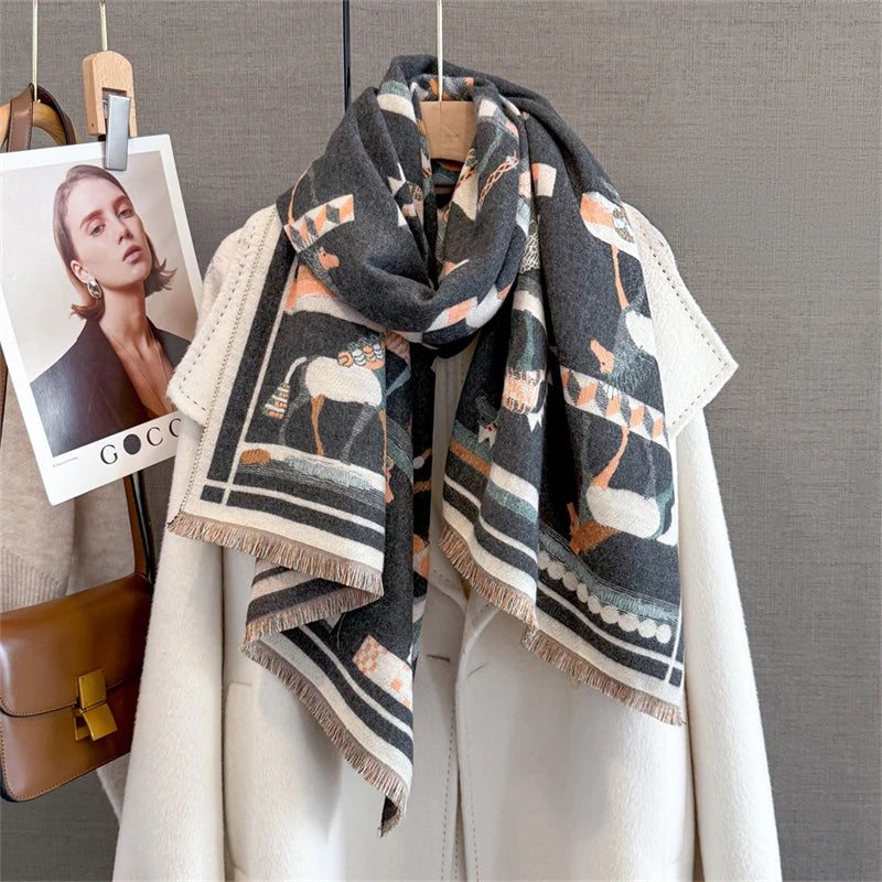 A gray and orange plaid cashmere scarf draped around a white coat, displayed on a hanger.