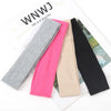 A collection of five knitted elastic headbands in shades of gray, pink, beige, and black displayed on white paper.