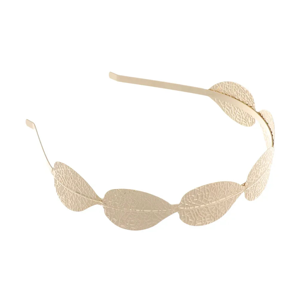 A delicate gold leaf headband featuring small, elongated leaves for bridal or party wear.