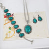 Silver turquoise stone jewelry set featuring a necklace and matching earrings displayed on a light background.