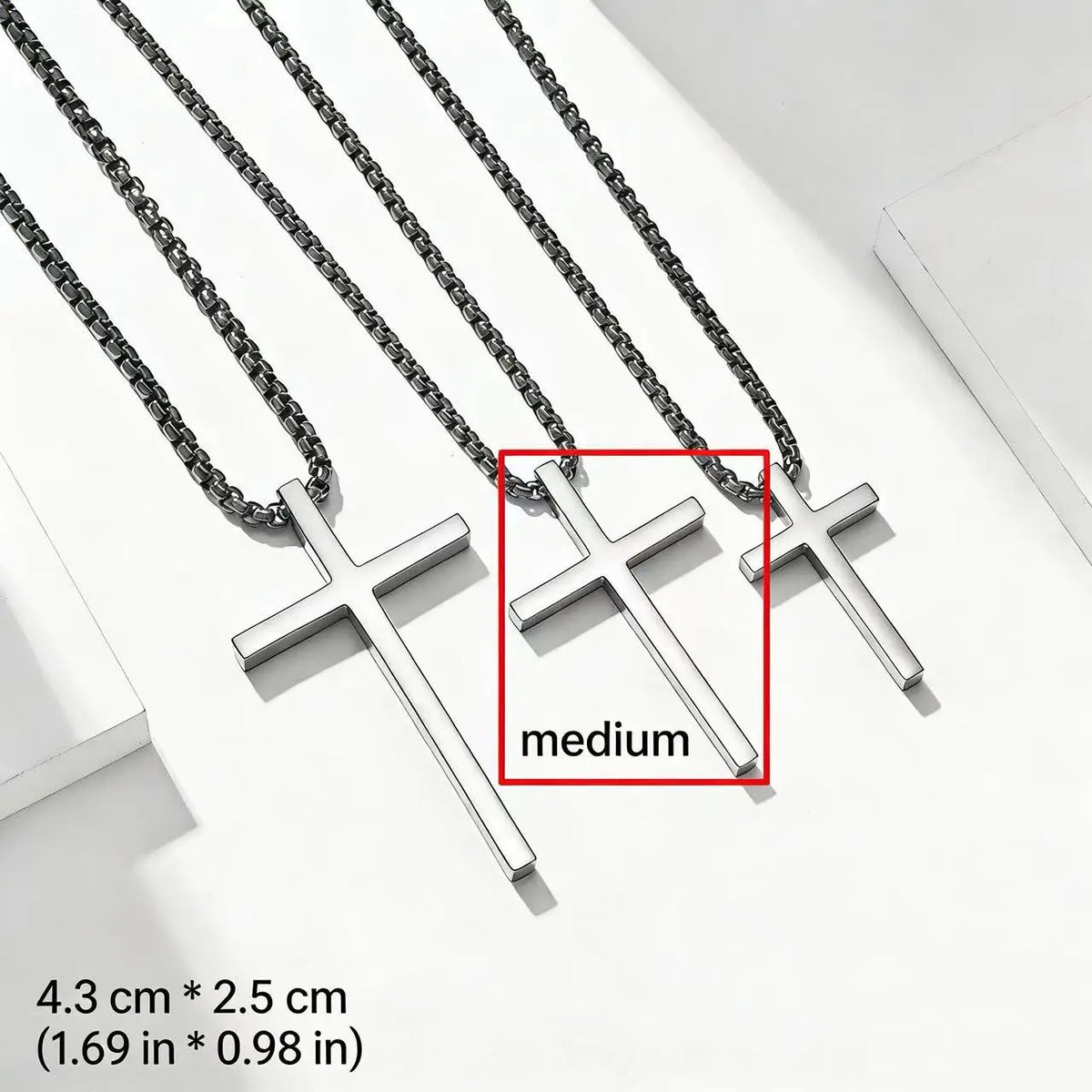 Silver stainless steel cross pendant necklace displayed on a white background.