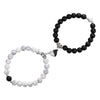 A pair of natural stone heart couple bracelets featuring black and white marbled stones.