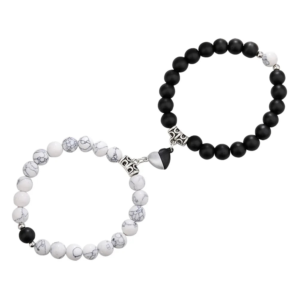 A pair of natural stone heart couple bracelets featuring black and white marbled stones.