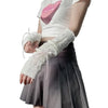 A person wearing white fingerless arm warmers and a light gray skirt, with a white t-shirt featuring a pink lip design.