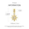 A gold-toned sun charm pendant with a circular design and rays, shown against a white background.
