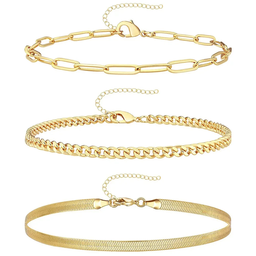 A set of three gold-colored waterproof stainless steel anklets for women displayed against a white background.