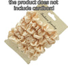 A pile of light pink satin hair scrunchies displayed on a cardboard tag.