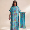 A woman models an elegant long silk blend cover-up robe dress featuring a vibrant blue and teal pattern.