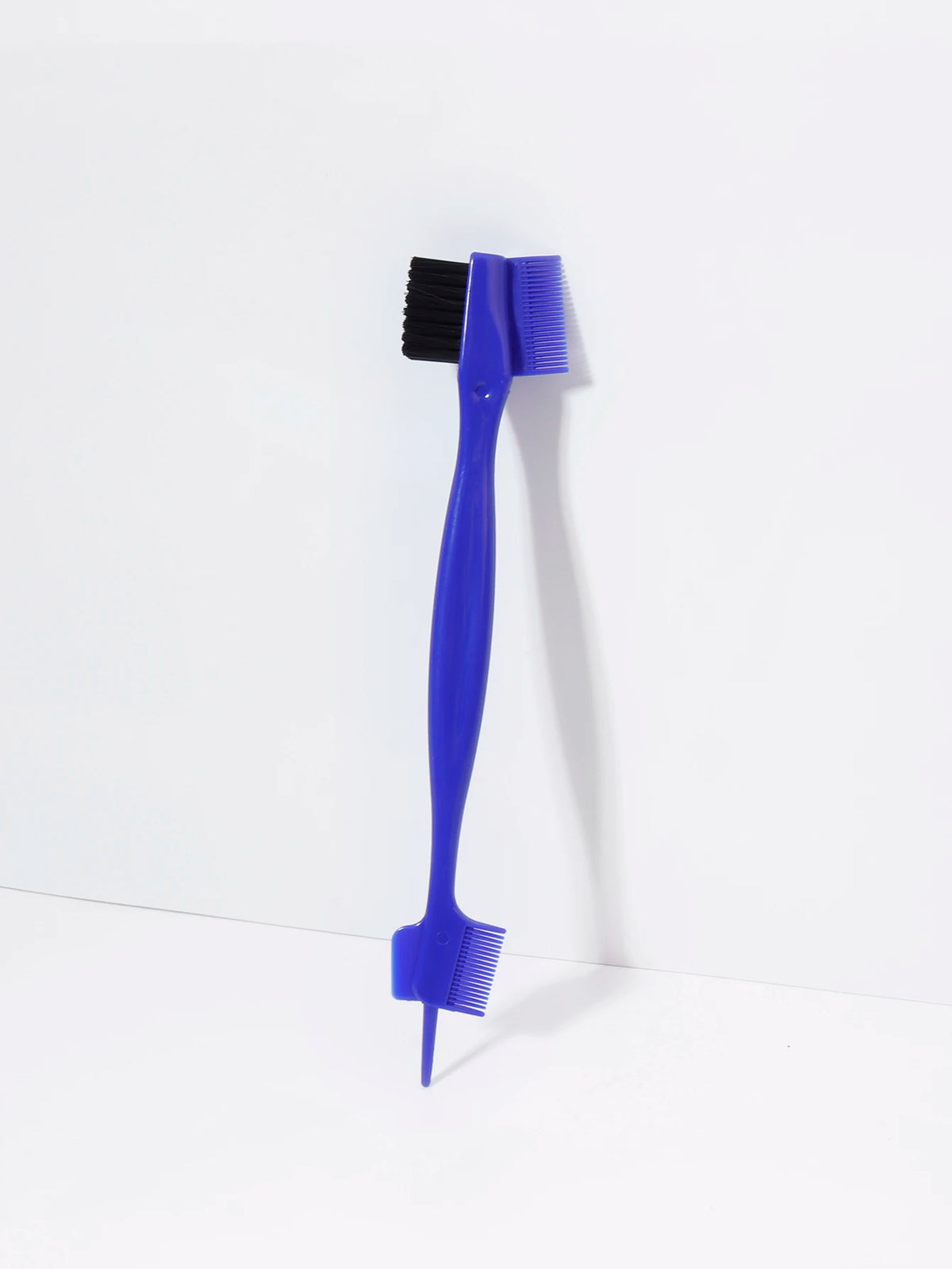 A bright blue precision edge control hair combing set with a black brush and a separate comb.