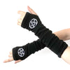 Black knitted fingerless gloves with a white pentagram design worn on a hand.