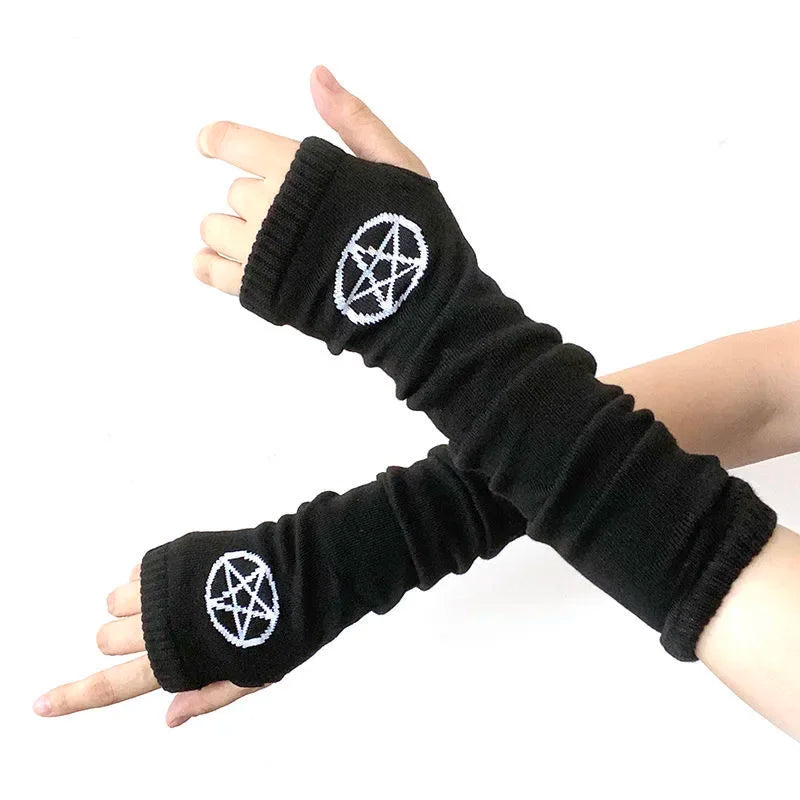 Black knitted fingerless gloves with a white pentagram design worn on a hand.