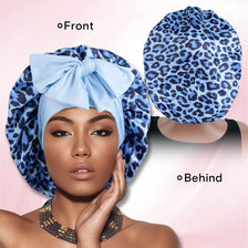 A woman wearing a blue leopard print satin sleep bonnet, shown from the front and behind.