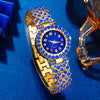 A gold-toned ladies quartz wristwatch with blue accents and a sapphire crystal case displayed on a blue velvet surface.
