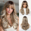 A model showcases a long, wavy sandy blonde wig with bangs and long hair, styled in soft waves.