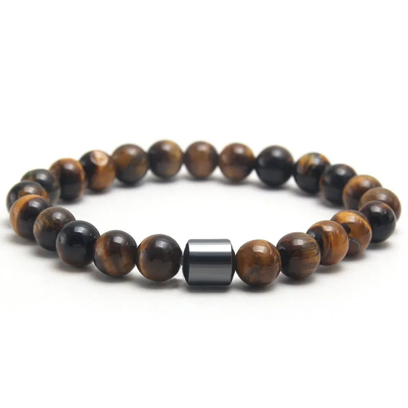 A bracelet made of polished tiger eye stones and a silver-colored bar.