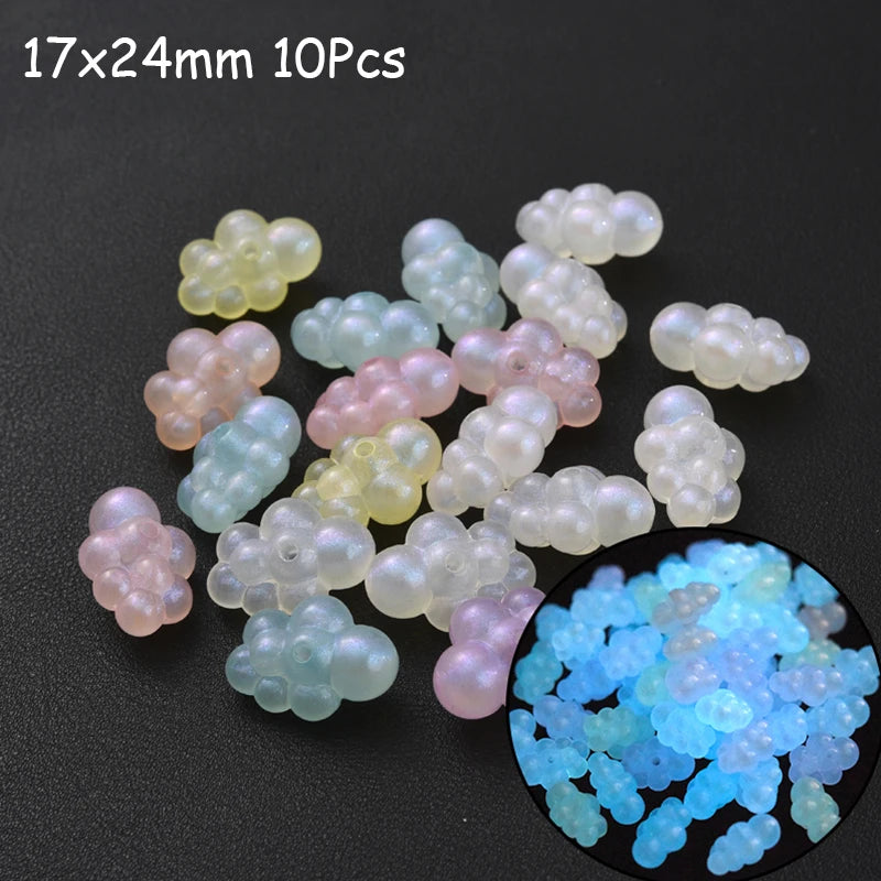 A collection of 10 translucent glow-in-the-dark acrylic beads in various shades of pink, yellow, and white.
