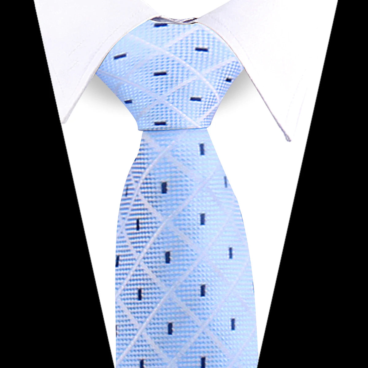 Light blue silk necktie with a subtle geometric pattern worn under a white shirt.