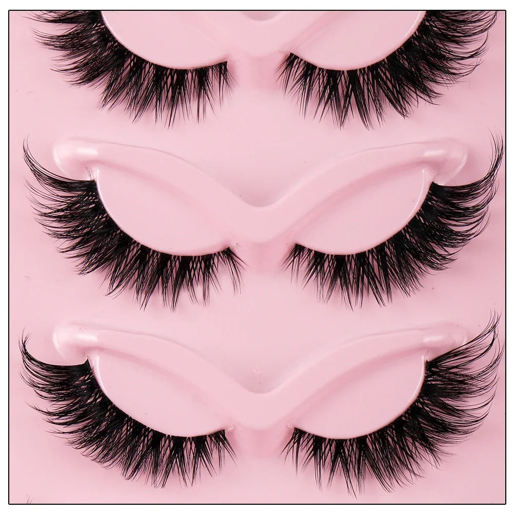 A pink plastic tray holding a pair of premium false cat eye strip eyelashes.