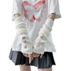 A person wearing white fingerless arm warmers with star details and a white t-shirt and dark skirt.
