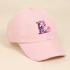 A pink baseball cap featuring a colorful rainbow unicorn design.