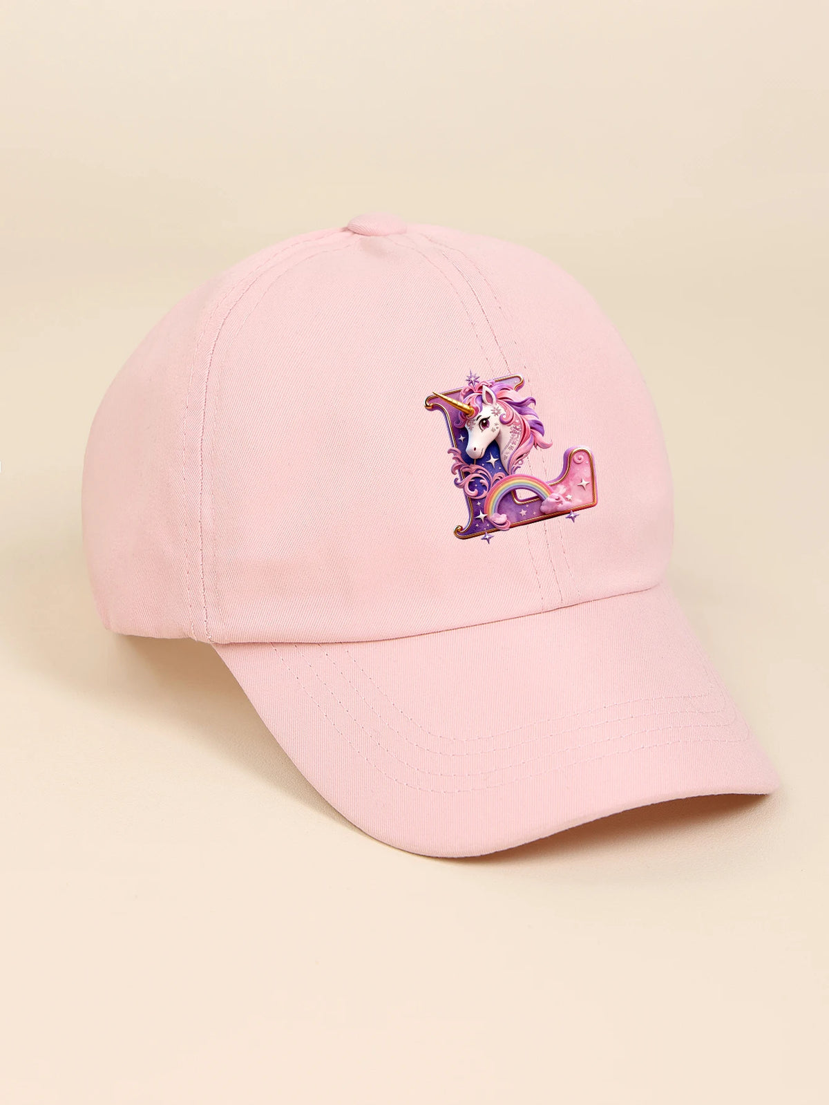A pink baseball cap featuring a colorful rainbow unicorn design.