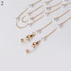 Gold chain lanyard with white pearl beads and a gold clasp for sunglasses