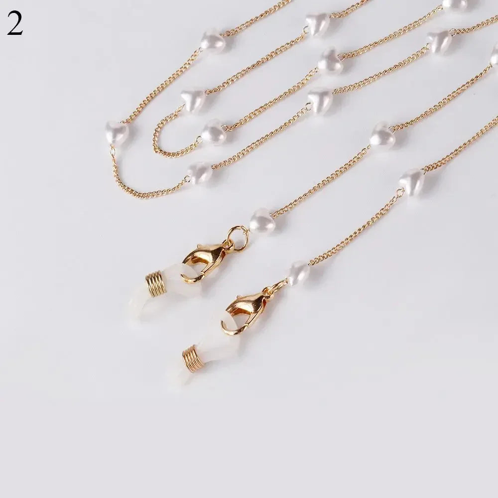 Gold chain lanyard with white pearl beads and a gold clasp for sunglasses