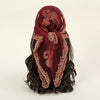 A deep maroon floral embroidered lace bandana headscarf tied around dark hair.