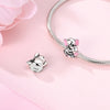 A sterling silver devil's eye charm bracelet with a small elephant charm displayed on a pink background.