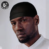 A man wearing a black moisture-wicking cycling beanie cap looking directly at the camera.