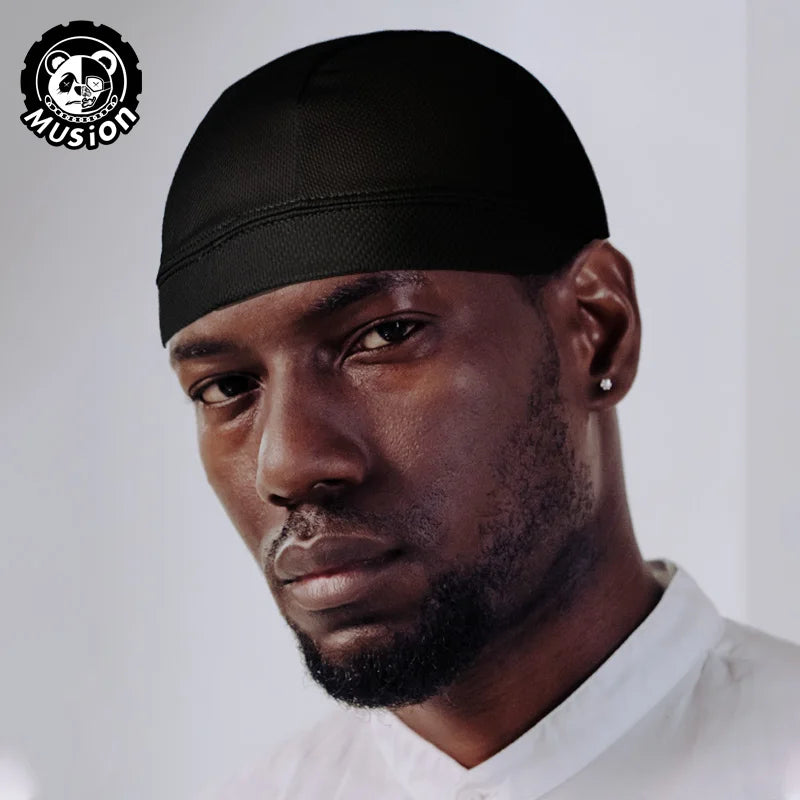 A man wearing a black moisture-wicking cycling beanie cap looking directly at the camera.