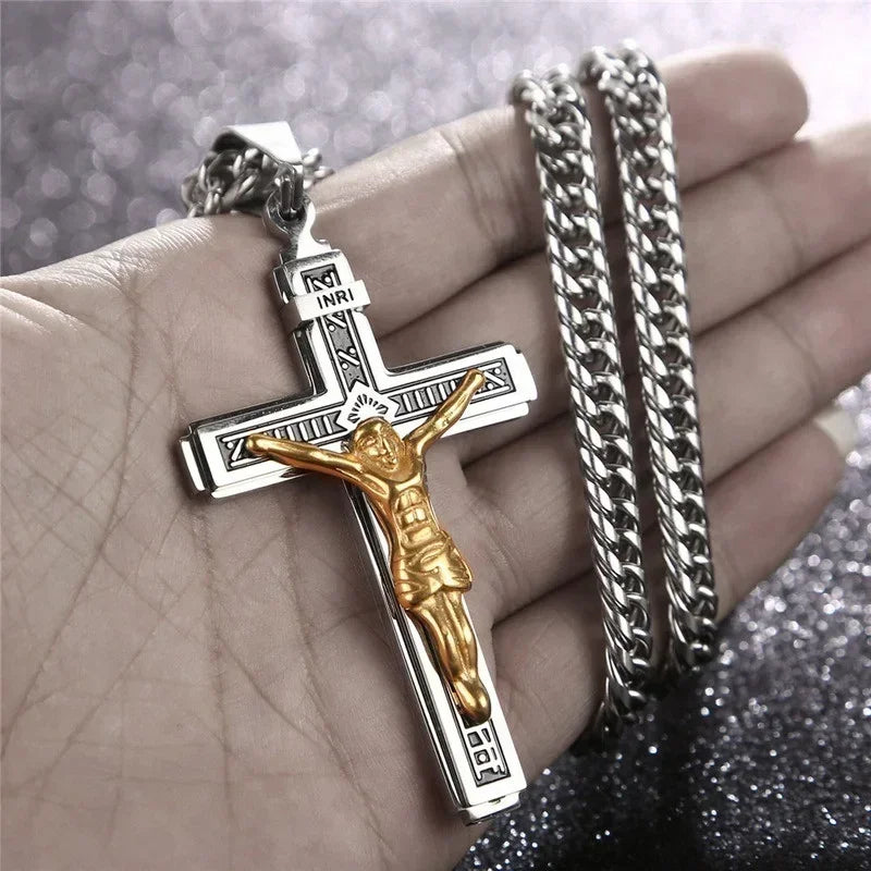 A gold-colored retro Christian cross amulet necklace is displayed on a person's hand next to silver chain bracelets.