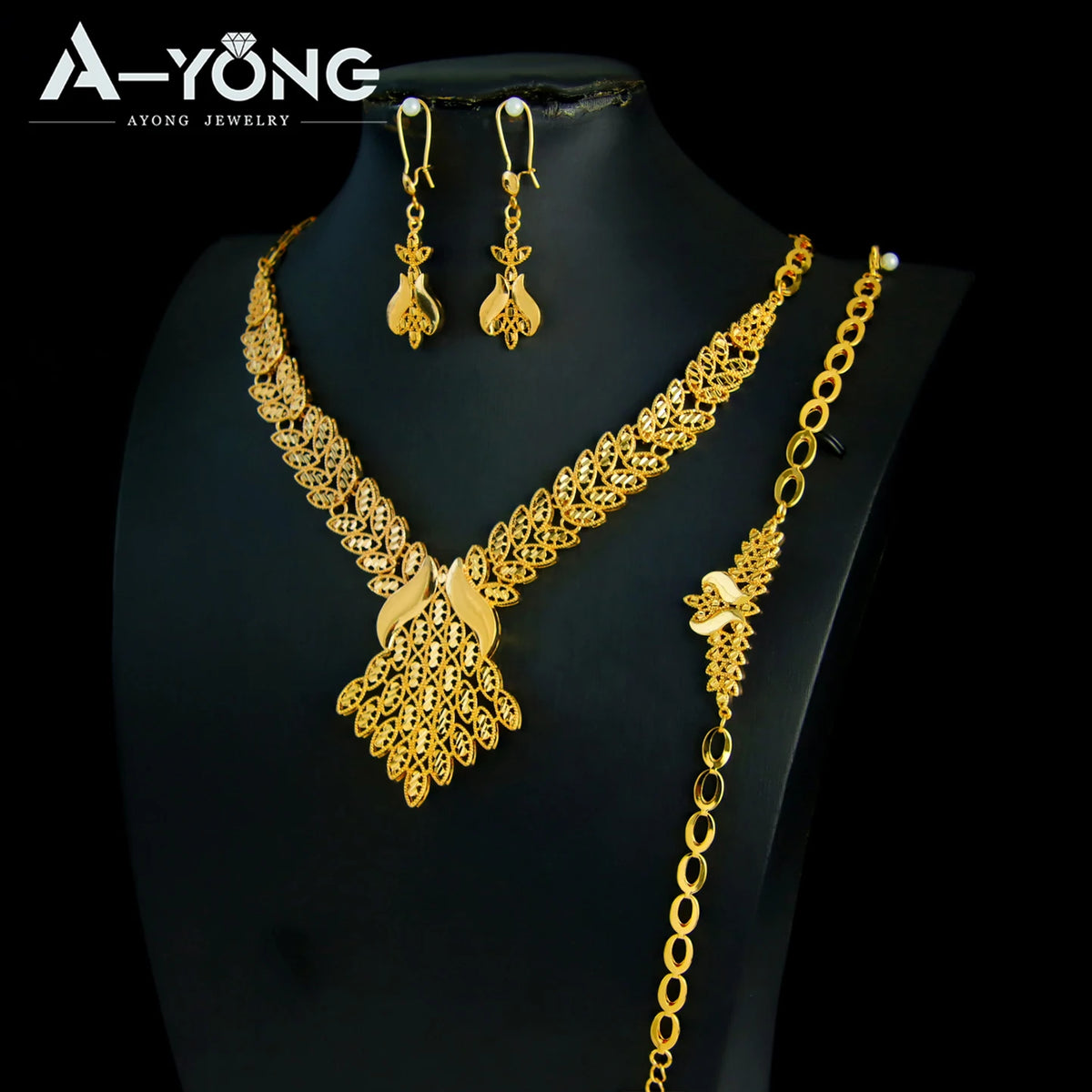 A luxury gold plated bridal jewelry set featuring a necklace and matching earrings displayed on a black mannequin.