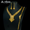 A luxury gold plated bridal jewelry set featuring a necklace and matching earrings displayed on a black mannequin.