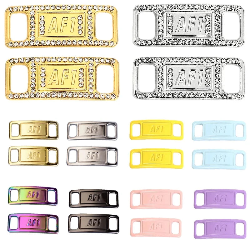 A collection of gold, silver, and pink acrylic shoe charms and laces with the letters AFI