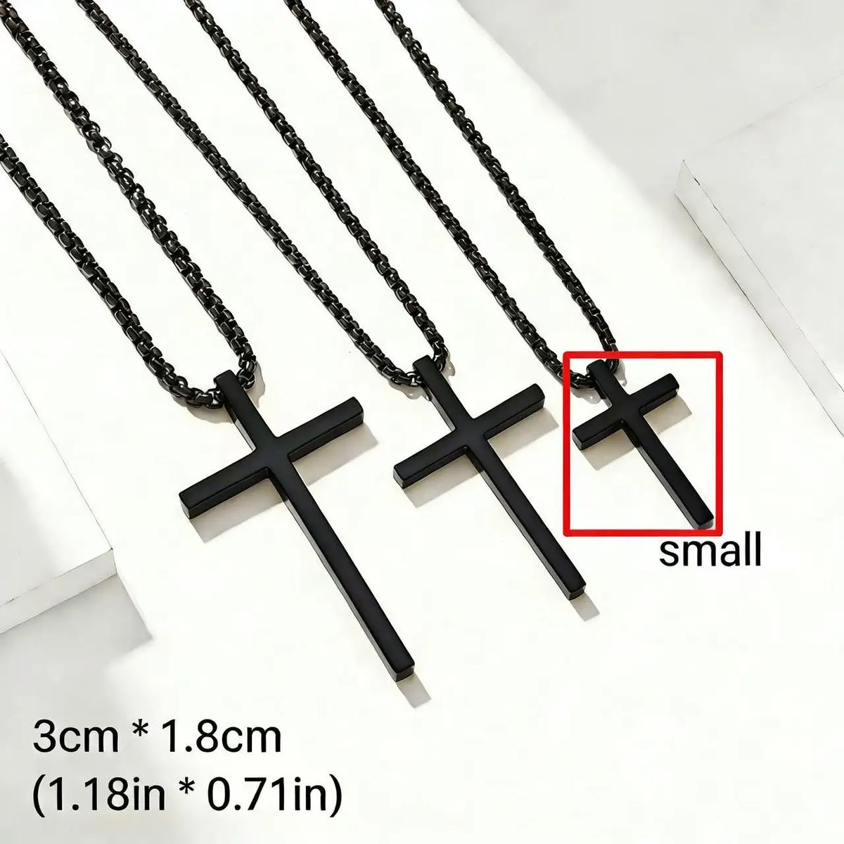 A set of small black stainless steel cross pendant necklaces displayed on a white background.