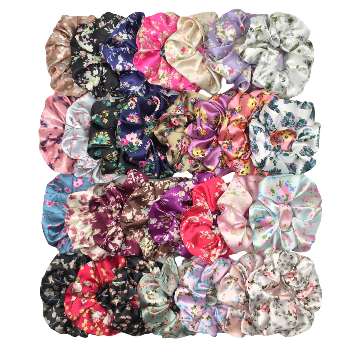 Un set de seis gomas para el pelo con estampado floral de satén en varios colores y patrones.