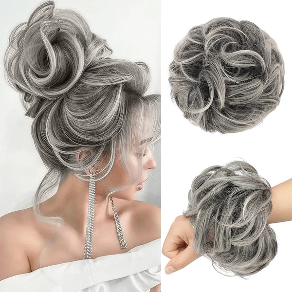 A woman's hair styled in a messy bun with silver gray highlights and delicate silver hair pieces.