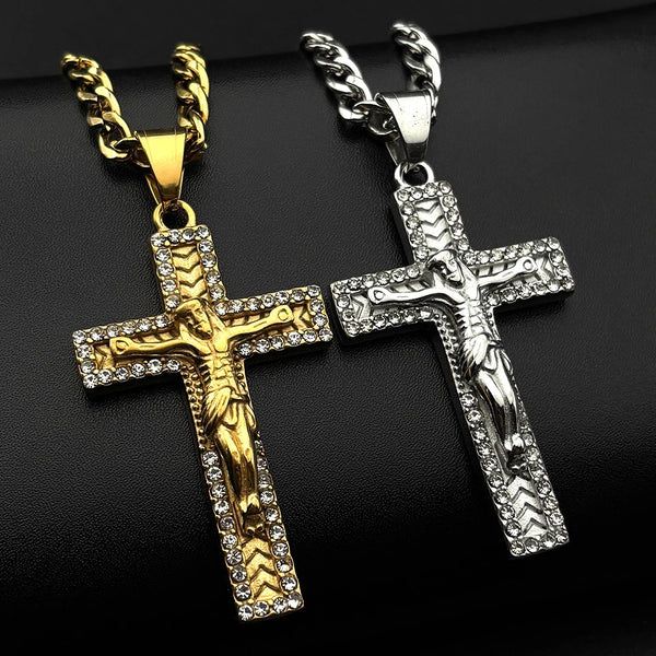 A pair of gold-tone stainless steel cross pendant necklaces with rhinestone accents displayed against a black background.