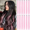 Long dark hair with pink highlights and ombre tips in a flowing style