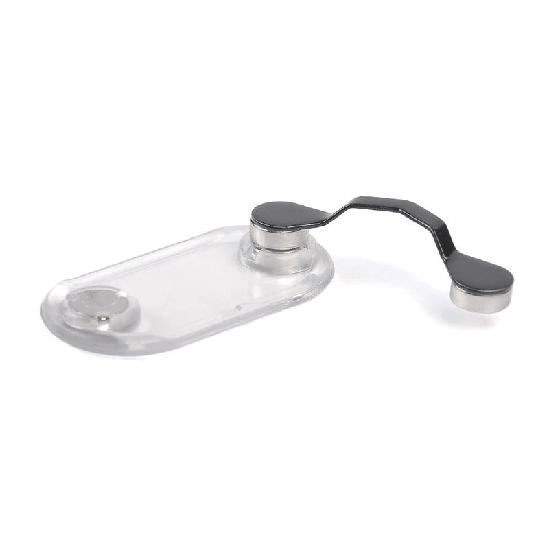A clear magnetic clip designed to hold eyeglasses.