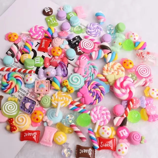A colorful set of 10 resin nail art charms featuring various shapes and glitter in pink, purple, green, and yellow.