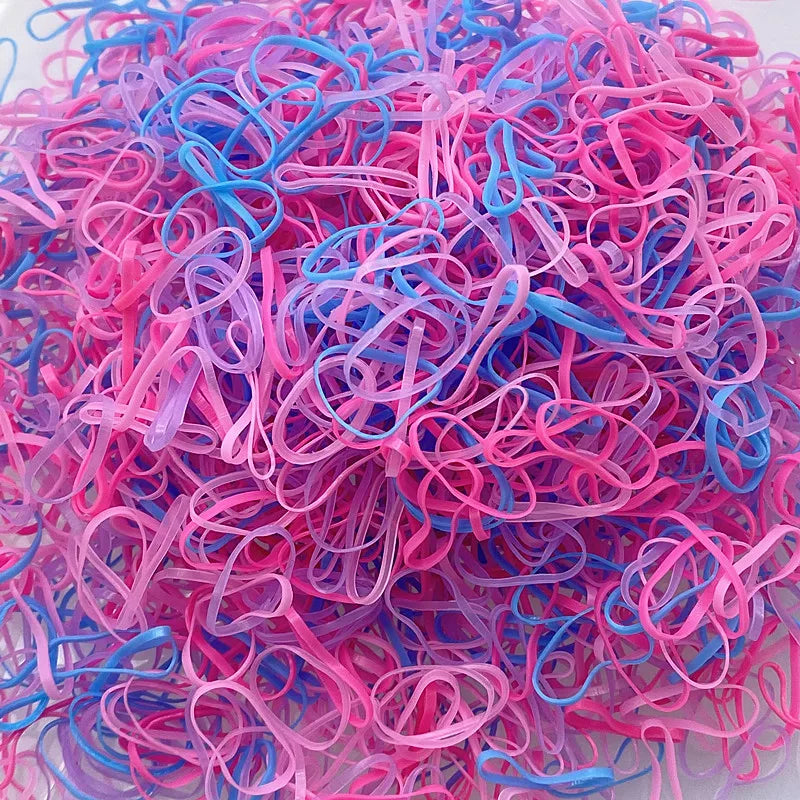 A pile of colorful disposable hair scrunchies in shades of pink, blue, and purple.