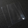 Three clear plastic card sleeves laid diagonally on a dark surface.