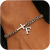 A close-up of a personalized stainless steel cross Cuban chain bracelet worn on a wrist.